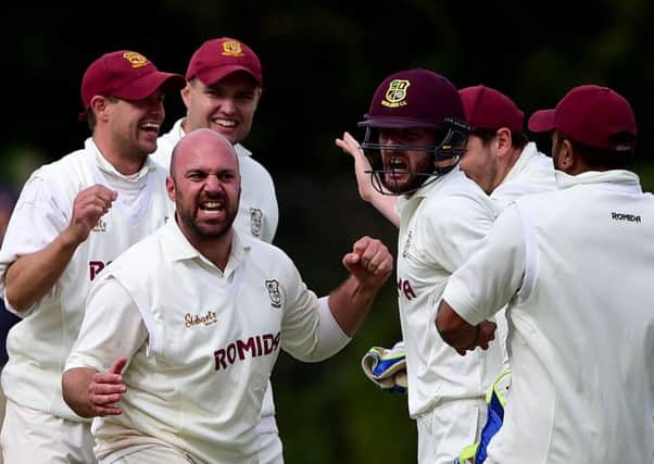 Woodlands spinner Chris Brice celebrates taking his third wicket in an over against Pudsey St Lawrence