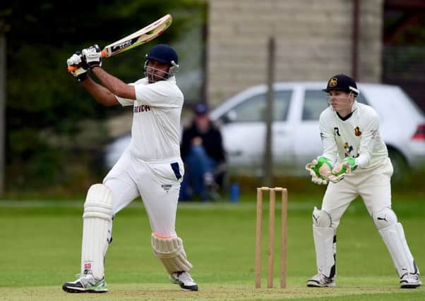 Sarfraz Ahmed produces a lusty blow for Woodlands against Pudsey St Lawrence last Saturday.