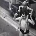 Dewsbury swimmer Jimmy Hey jumps into the pool with his daughter, Jeanette.