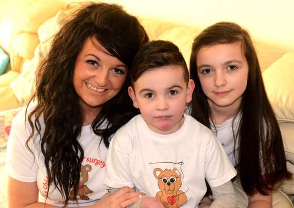 Alfie with sister Chloe and mum Emma. (d624a507)