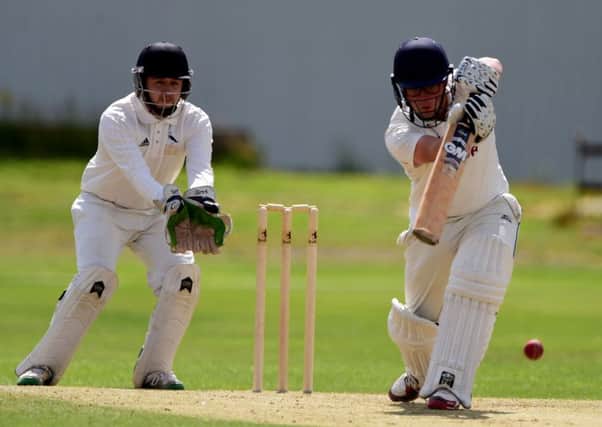 Woodlands batsman Jack Carter on the drive as Hanging Heaton wicketkeeper Francis Nelson looks on during last Sundays Priestley Shield final.