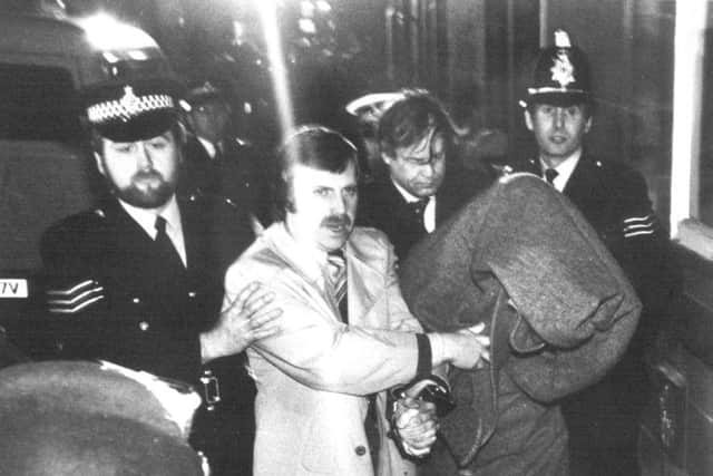 Yorkshire Ripper. Peter Sutcliffe, covered by a blanket and handcuffed to a police officer, is taken into Dewsbury Magistrates' Court after his arrest in 1981.