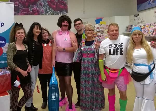 Staff at Tesco donned their 70s and 80s gear and helped raise Â£775 for charity.