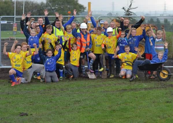 East Bierley AFC, Hunsworth AFC and Birkenshaw Bluedogs ARLFC members celebrate after securing funding to revamp the clubs' sports facilities.