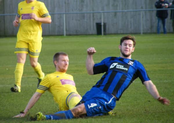 A Liversedge defender challenges for the ball during Saturdays clash at Cleethorpes Town. Picture: Andy Taylor
