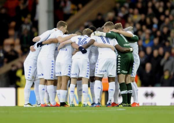 Leeds United players show their togetherness before the game at Nowich.