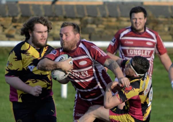 Thornhill Trojans forward Wayne Wilson attempts to force his way through the Worth Valley defence during his sides emphatic Pennine League victory last Saturday. Picture Dave Jewitt
