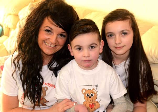 Alfie with sister Chloe and mum Emma. (d624a507)