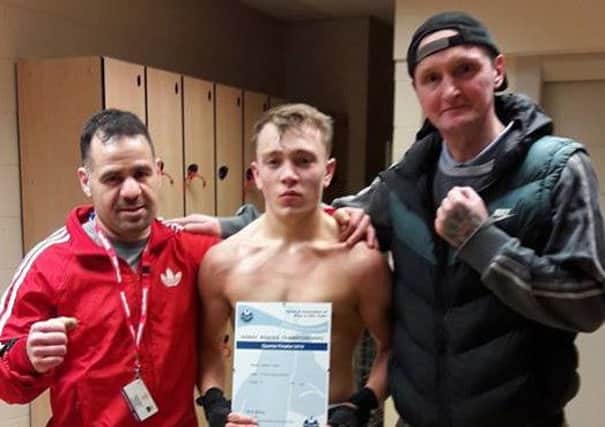 Jordan Yates celebrates his victory in Durham with coach Abed Rahman and Mark Hurley of Dickys Gym in Batley.