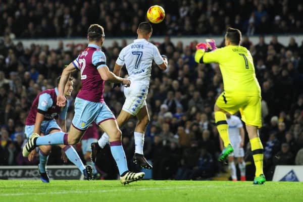 Kemar Roofe heads in his first goal for Leeds United as the Whites beat Aston Villa.