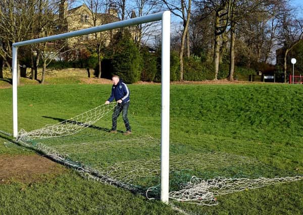 Paul Riordan, of St John Fisher takes down the nets after their West Riding County Cup tie with Heckmondwike was called off.Pictures: Paul Butterfield