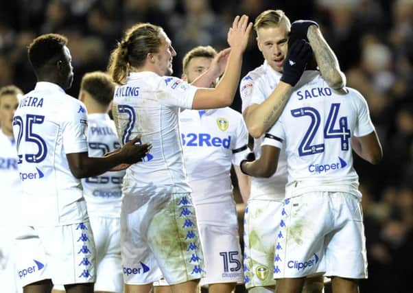 Leeds United players celebrate their second goal that clinched victory against Aston Villa and took them to fourth place.