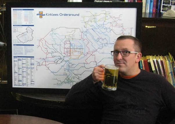 Pub maps author Steve Lovell with a pint and his Kirklees map