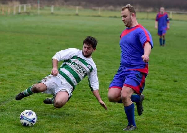 Joe Ratcliffe of Birstall St Patricks challenges a Clifton Rangers player last Sunday.