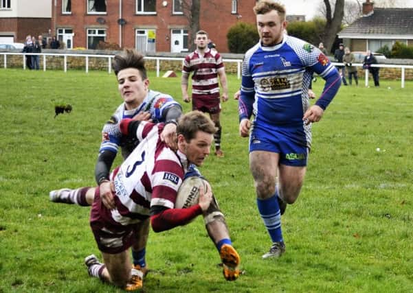 Ryan Fenton is tackled short of the line during Thornhill Trojans Ladbrokes Challenge Cup victory over Lock Lane at Overthorpe Park last Saturday.