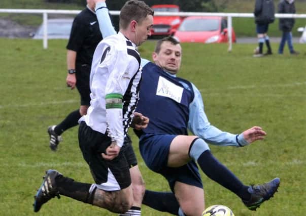 Overthorpe's  Tom Hirst attempts to beat the challenge of a Westgate rival during the Heavy Woollen Sunday League Division Two clash. Picture: Dave Jewitt.