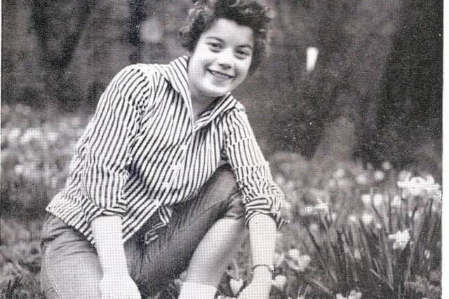 IN FOCUS: Young weaver Marlene Walls is shown posing among crocuses for the firms spring edition of its quarterly magazine.