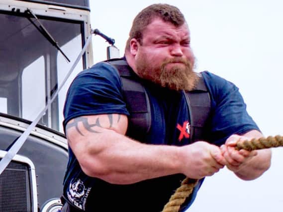 How strongman Eddie 'The Beast' Hall takes the bus in Leeds - puling it with his bare hands.