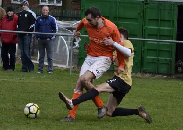 Overthorpe's Lewis Ward is brought down by a Linthwaite defender in the Heavy Woollen Sunday League Championship.