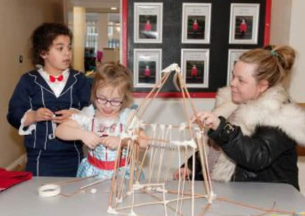 LIGHT WORK: Children are shown how to build their own lanterns at last years Lantern Land event.