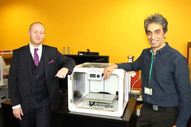 Mr Hawksworth, left, is pictured with Bradford Colleges Zaid Bashir and one of the donated printers.