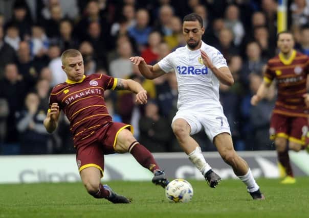 Leeds United's Kemar Roofe is challenged by QPR's Jake Bidwell. Picture: Simon Hulme