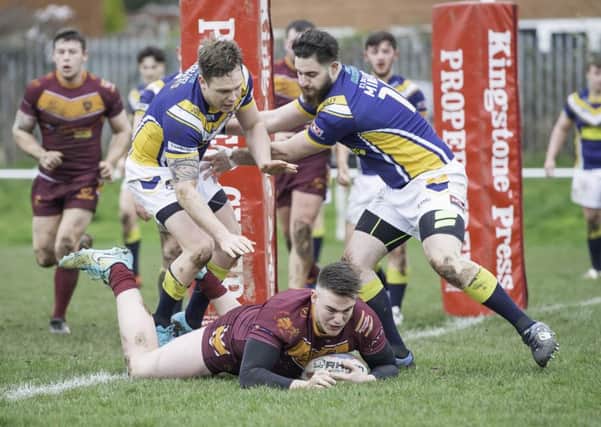 Dewsbury Moor's 19-year-old prop forward Connor Gavaghan forces his way over to score against Clock Face Miners.