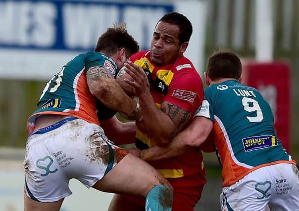Dewsbury Rams forward Jode Sheriffe is wrapped up by Hull KR defenders James Donaldson and Shaun Lunt last Sunday.