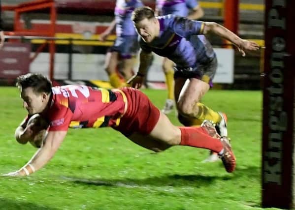 Aaron Ollett dives over to score for Dewsbury against Newcastle.