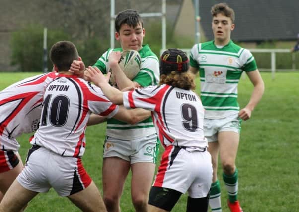A Dewsbury Celtic attacker is halted by the Upton defence during last Sundays Yorkshire Junior League Under-16s Division Two clash.