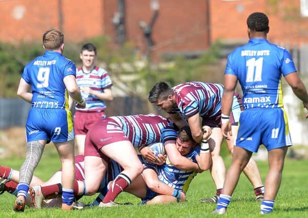 A Batley Boys attacker is brought down by the Toll Bar defence during last Saturdays Yorkshire Mens League Premier Division clash at Staincliffe. Picture: Andy Bellis.