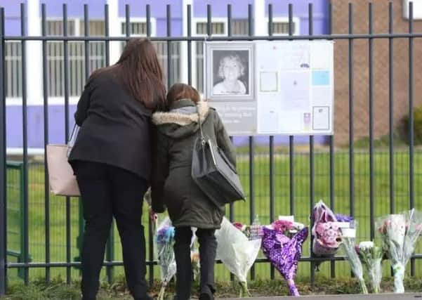 Flowers are left at the gates of Corpus Christi Catholic College in Leeds following the murder of Ann Maguire. Picture: Ian Hinchliffe/RossParry.co.uk
