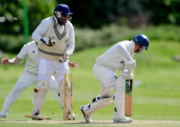 Moorlands batsman Darrell Sykes is bowled by Hanging Heaton spinner Callum Geldart during last Sundays Heavy Woollen Cup second round tie at Memorial Park.