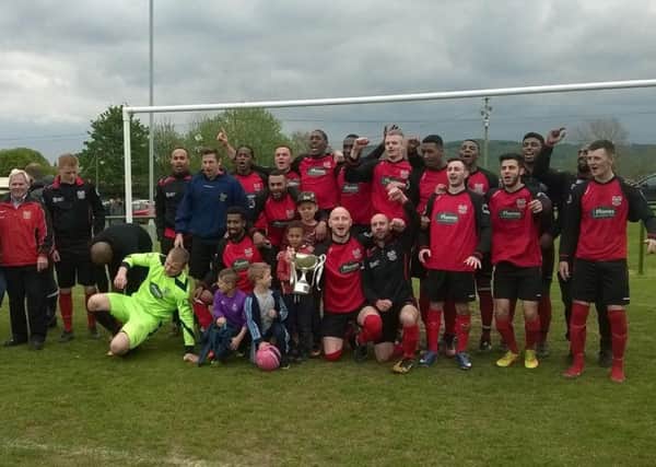 Lower Hopton players and committee celebrate winning the West Riding County Amateur League Premier Division title for the first time.