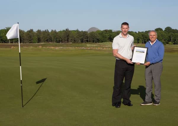 Dewsbury District golfer Ben Crowther receives his prize from Jerry Sarvadi, CEO of the Renaissance Club.