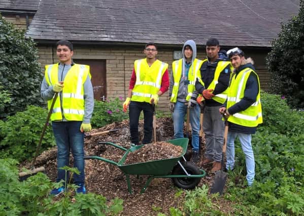 FIRST DAY: Kirklees College students start the transformation of the new garden.