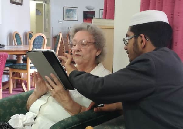 WELL CONNECTED: An elderly resident at Wellington Court gets some expert help during the special visit.