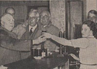 NEW ERA: Serving the first drinks at the new Three Nuns Hotel in 1939.