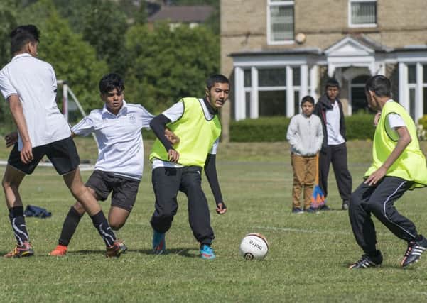 Picture by Allan McKenzie/YWNG - 25/07/15 - Press - Kumon Y'All Football Tournament - Savile Town, Dewsbury, England - Kids from the teams playing football at the tournament.