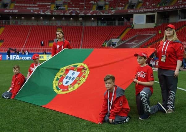 FLAG BEARER: Harvey Hardill is shown crouching at the red side of the Portuguese flag.