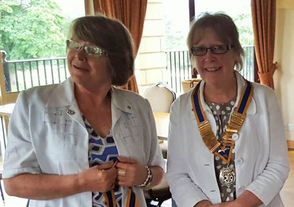 CHANGE: Sue Young hands over the chain of office to Gill Poole.