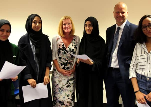 Celebrating A-level results at Batley Girls High School are, from the left, 
Habeebah Nadeem, Simone Mahmood, Julie Haigh (co-head), Tasneem Esmail, David Cooper (co-head], and Hawa Patel