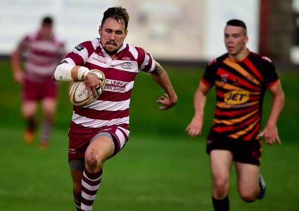 Danny Ratcliffe races upfield to score a 28th minute try which put the Trojans ahead.