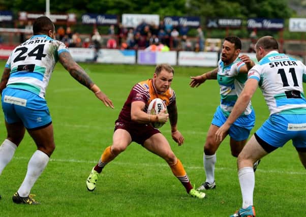 Dominic Brambani attempts to find a way past Rams defenders Jode Sheriffe, Paul Sykes and Rob Spicer.