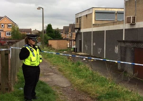 Police officer at the scene of an axe attack near Town Gate in Wyke, Bradford.