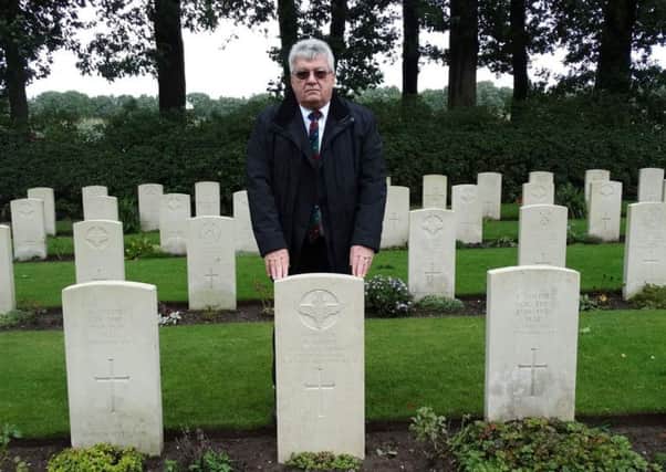 Dewsbury local historian Peter Bennett at Paratrooper Lance Corporal William Loney's grave, with its new headstone, in Holland. Picture: Danielle Roubroeks