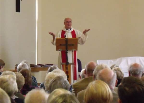 NEW ERA: Rev Dr Roger Walton leads the celebration service.