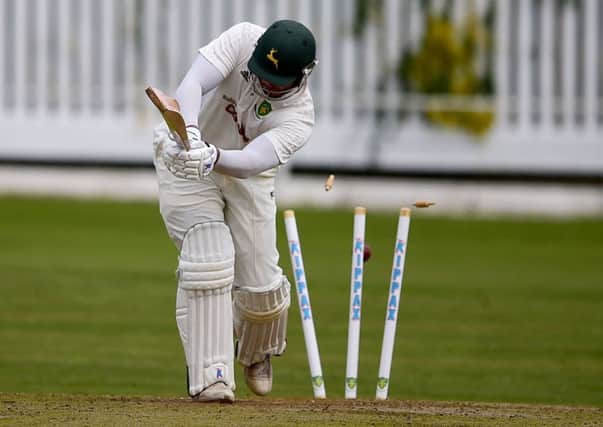 Wrenthorpe batsman Greg Wood has his stumps uprooted by Scholes bowler Andrew Robinson during last Saturdays Bradford League Championship One clash. Picture: Paul Butterfield.