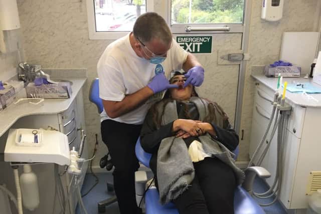 Nick O'Donovan examines Kirklees Councillor Rosheen Dad at the Dentaid mobile dental service