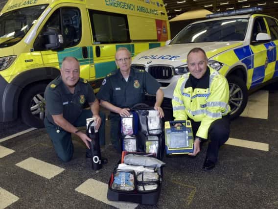 West Yorkshire Police's Superintendent Mark McManus, right, with Yorkshire Ambulance Service's head of community resilience, Paul Stevens, and community defibrillator officer Neil Marsay. Picture: Steve Riding